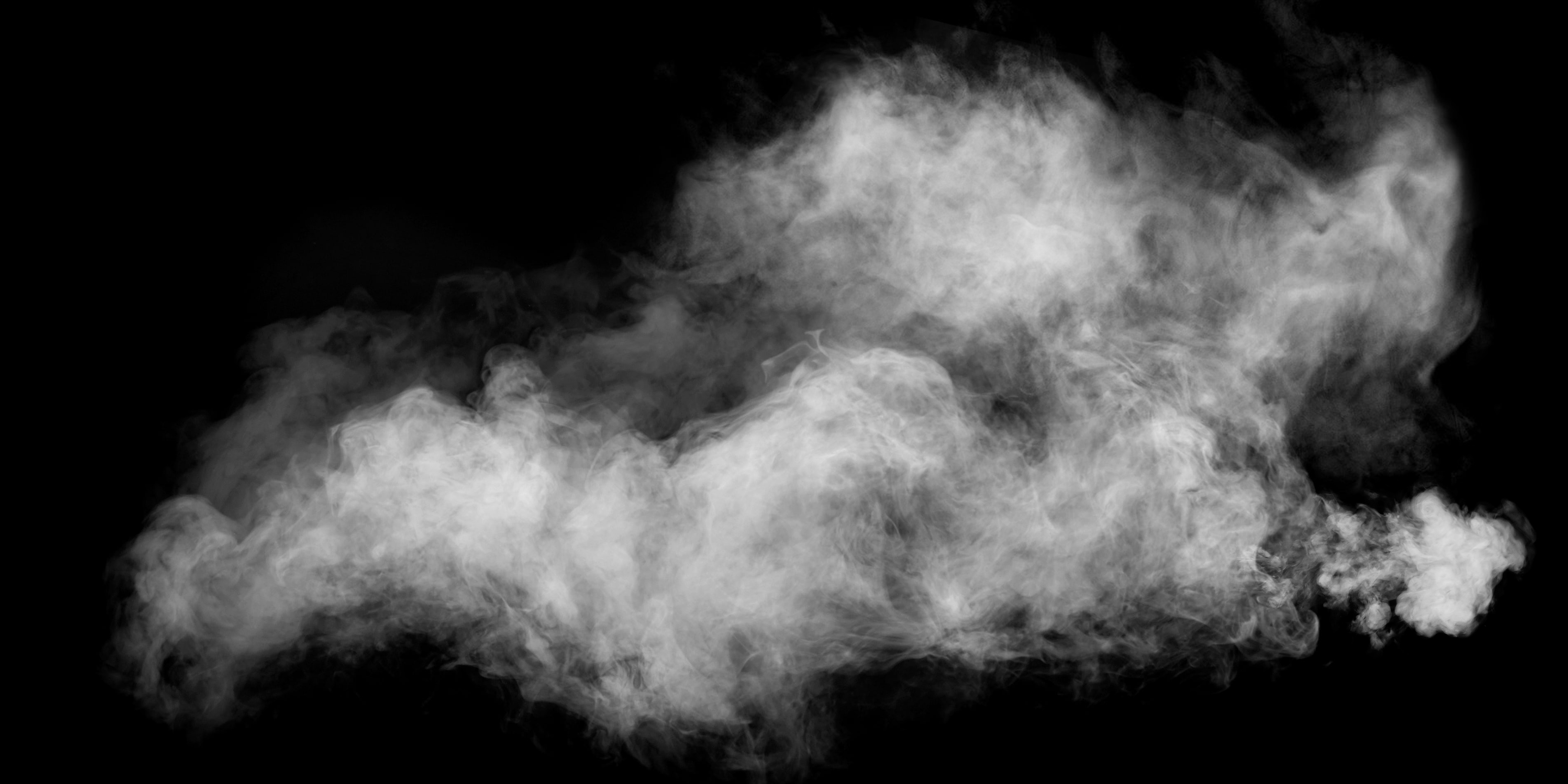 White smoke or steam billowing against a black background
